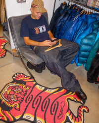 Orange Tuned Tiger rug on the floor, shown for size