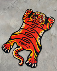 Orange Tuned Tiger rug laid flat on concrete
