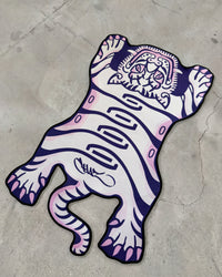 Purple Tuned Tiger rug laid flat on concrete